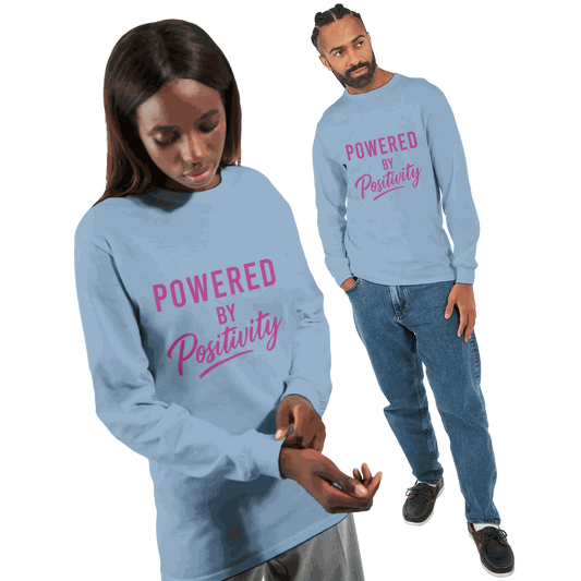 Unisex long sleeve t-shirt in light blue with "Powered by Positivity" motivational text in pink font